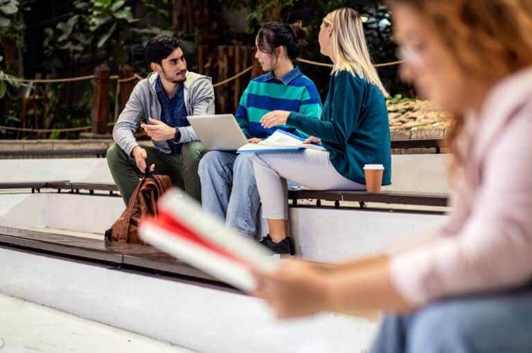 Diverse group of student siting in campus learning together